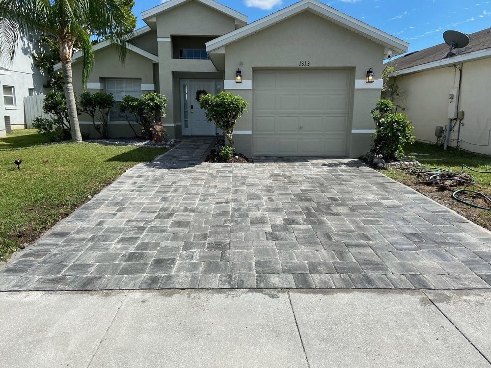 Paver driveway with contrasting border in front of a Florida home